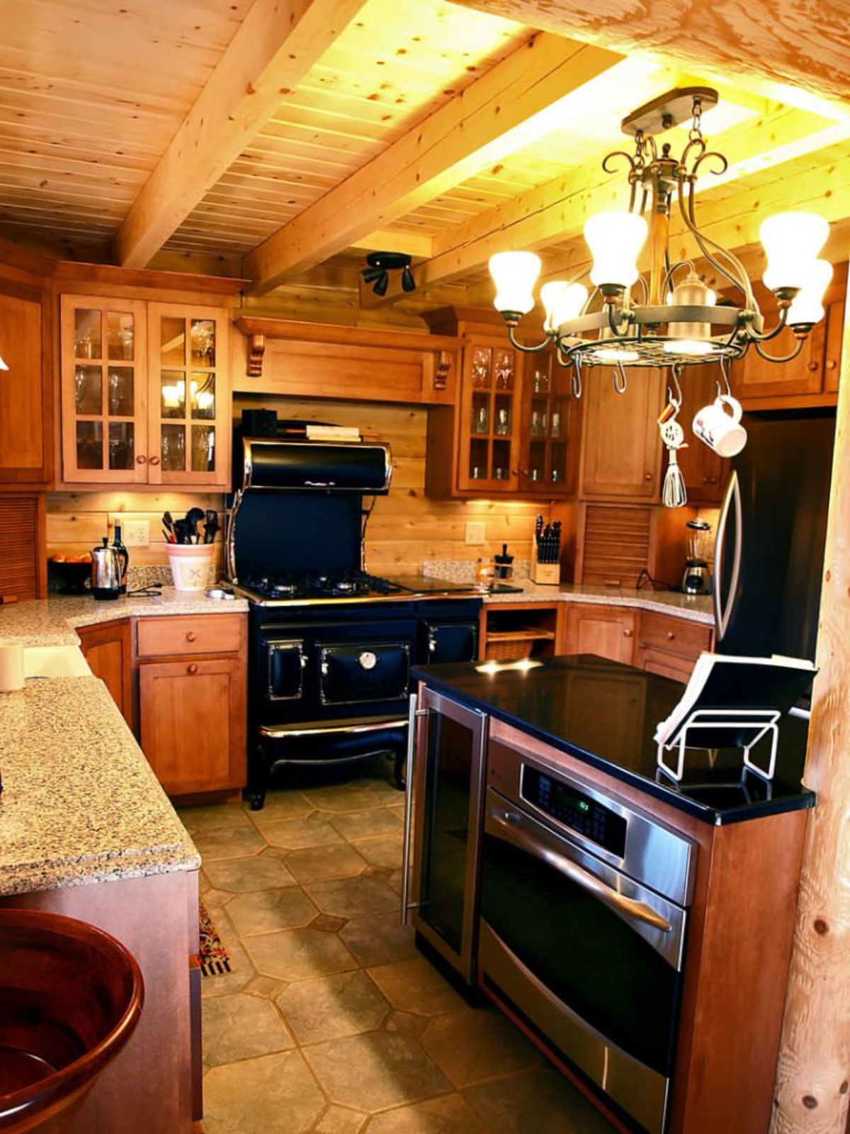 corner kitchen with black appliances and wood cabinets