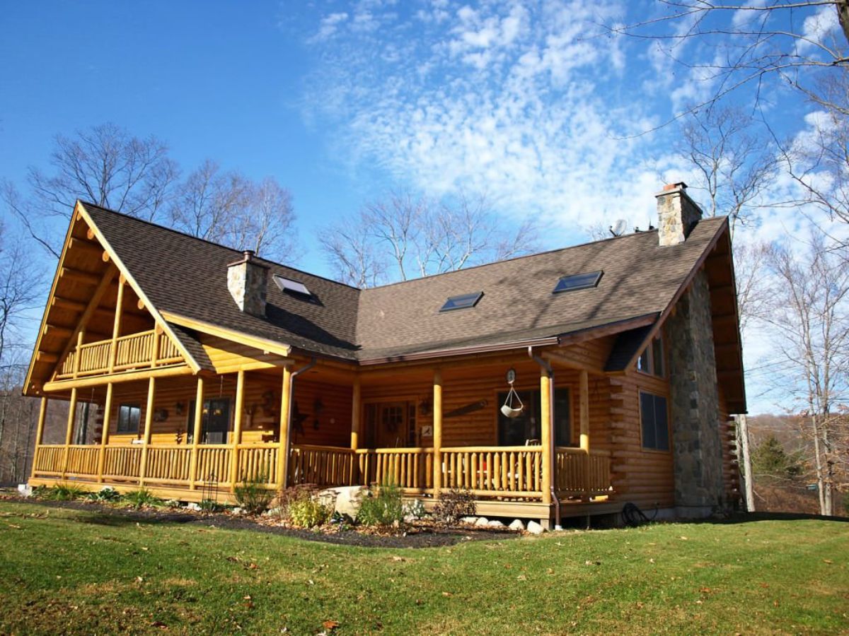 log cabin with l shape and covered porch