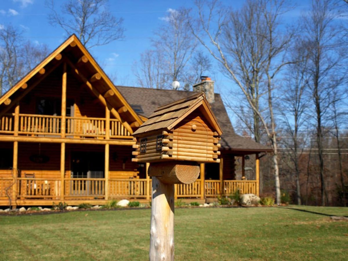 log cabin with mini cabin mailbox out front