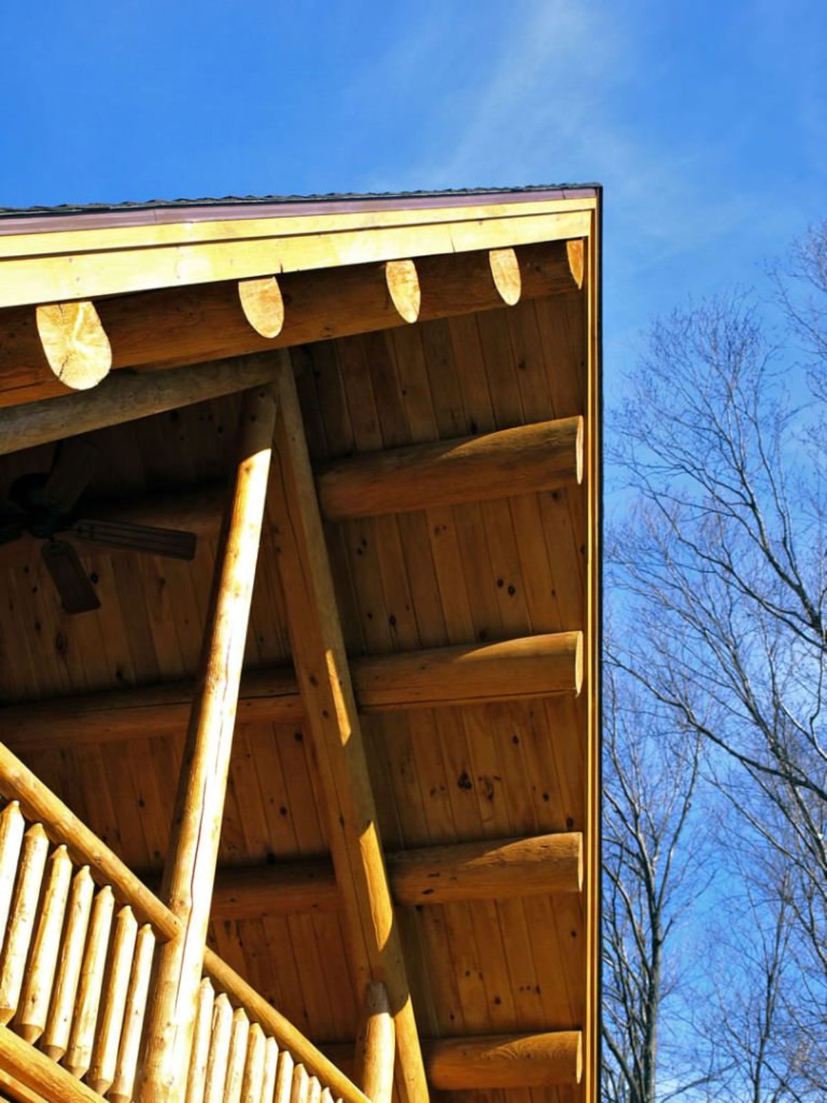 log eaves of porch with ceiling fan