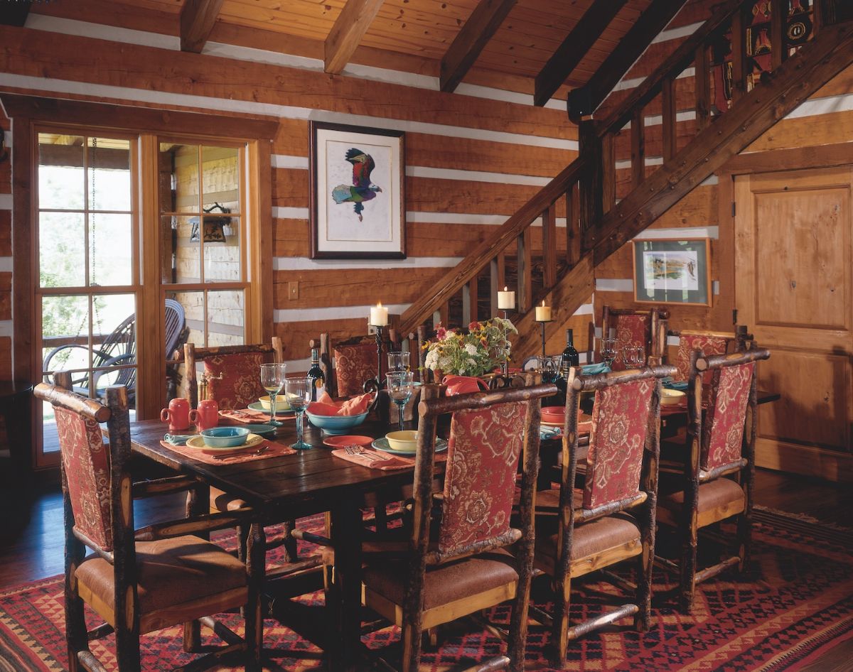 dark wood dining table with loft stairs in background