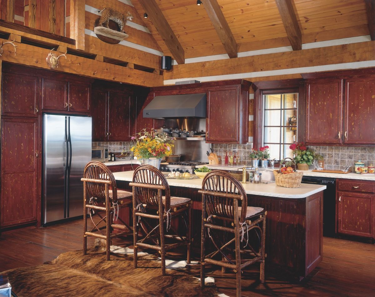 bar with stools against outside edge of living room in log cabin