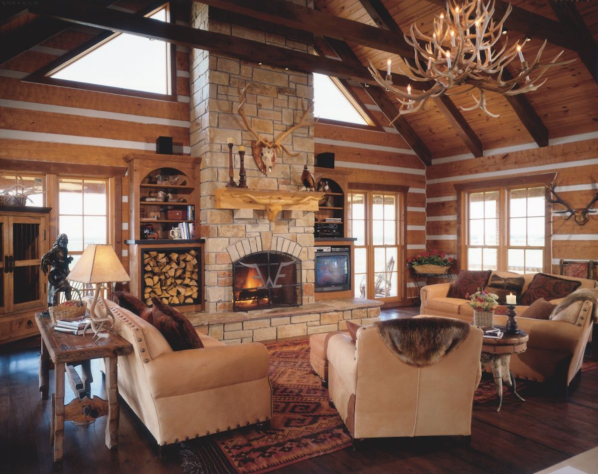 beige chairs around living area with fireplace against far wall