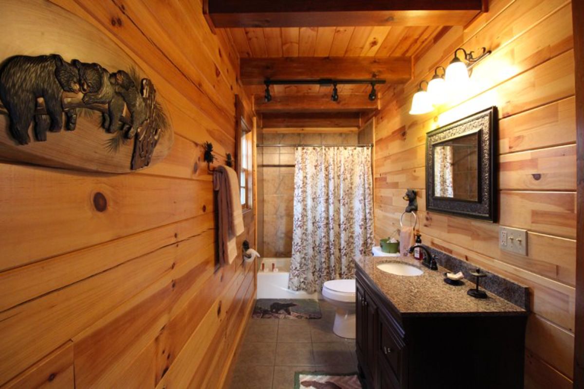 bathroom with shower and bathtub combination at back of space