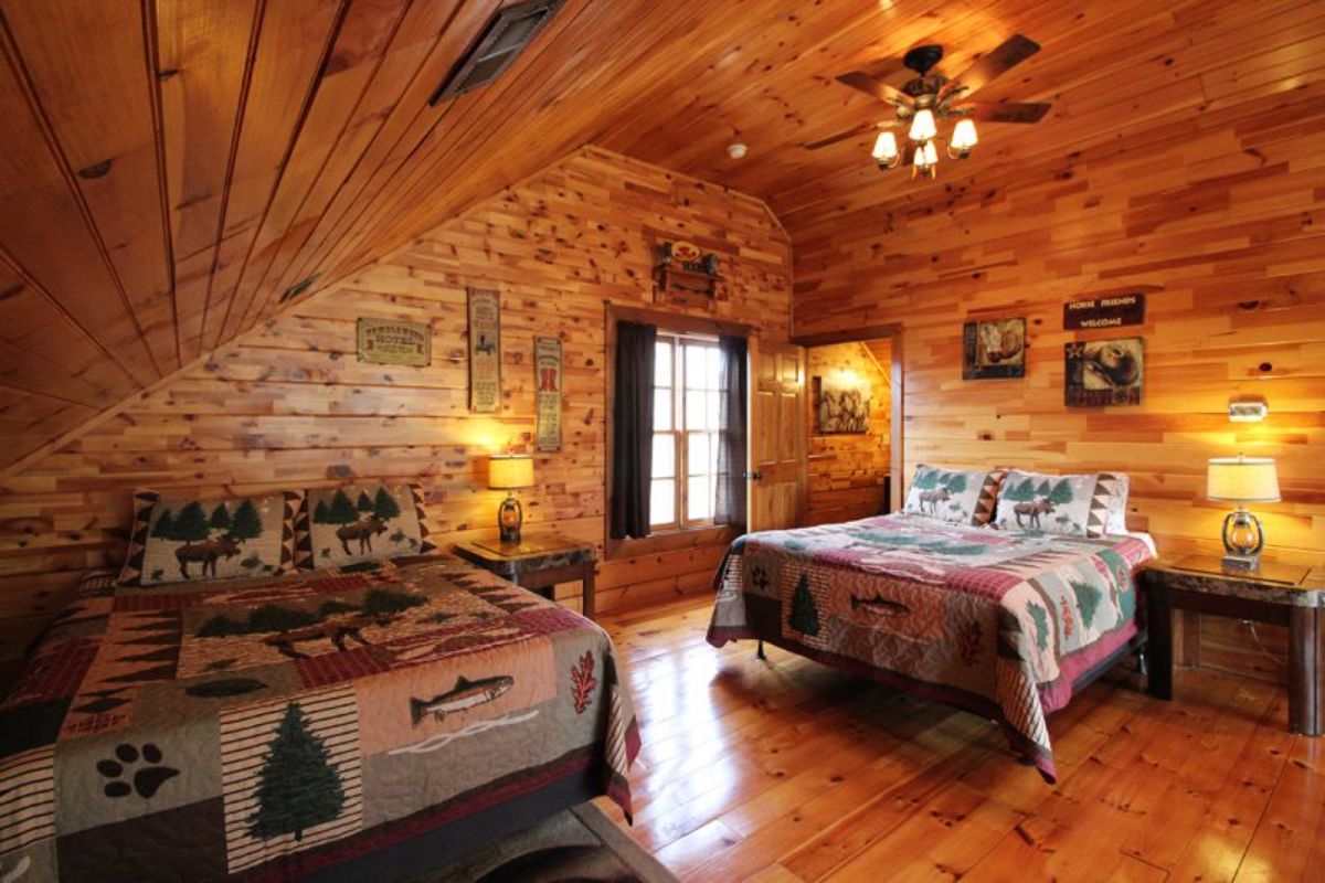 loft bedroom with two beds and window on far wall