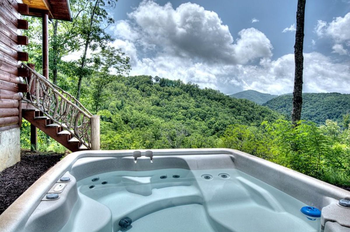 light blue hot tub overlooking mountains