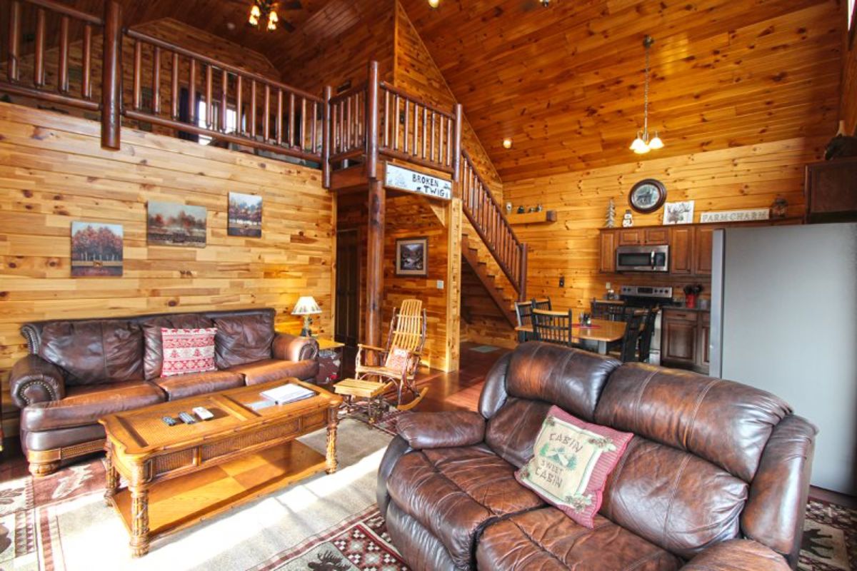 main floor of log cabin showing hall and stairs in background