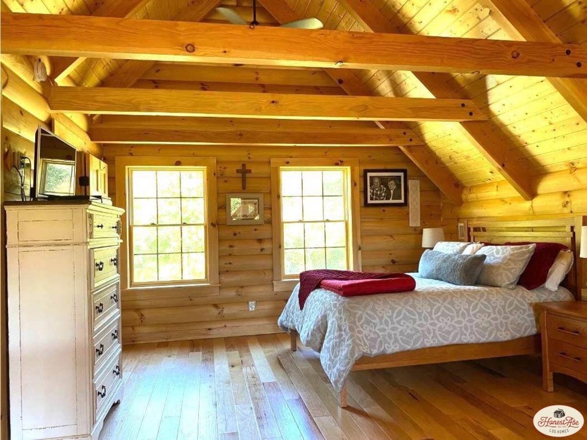 white bedding on bed beneath loft in cabin
