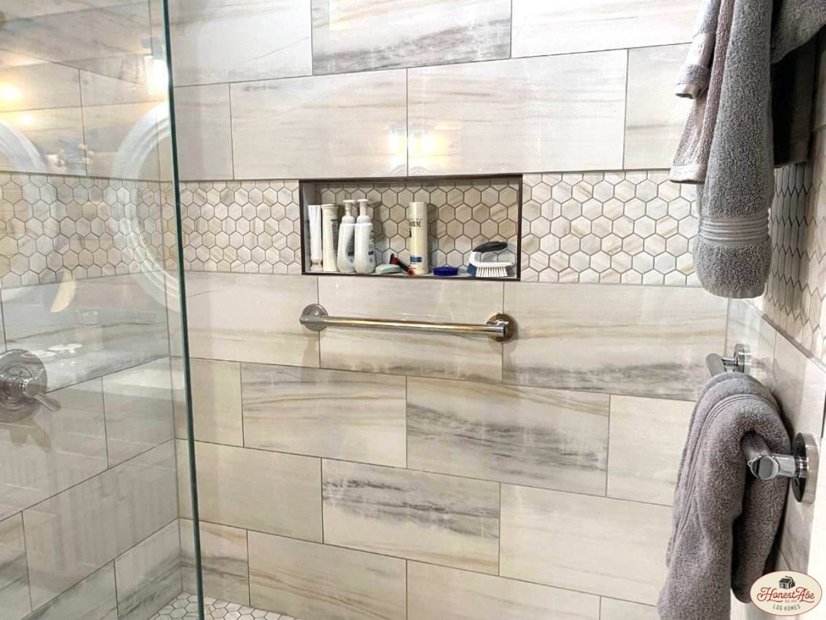 grey tiled shower with built in shampoo cubby