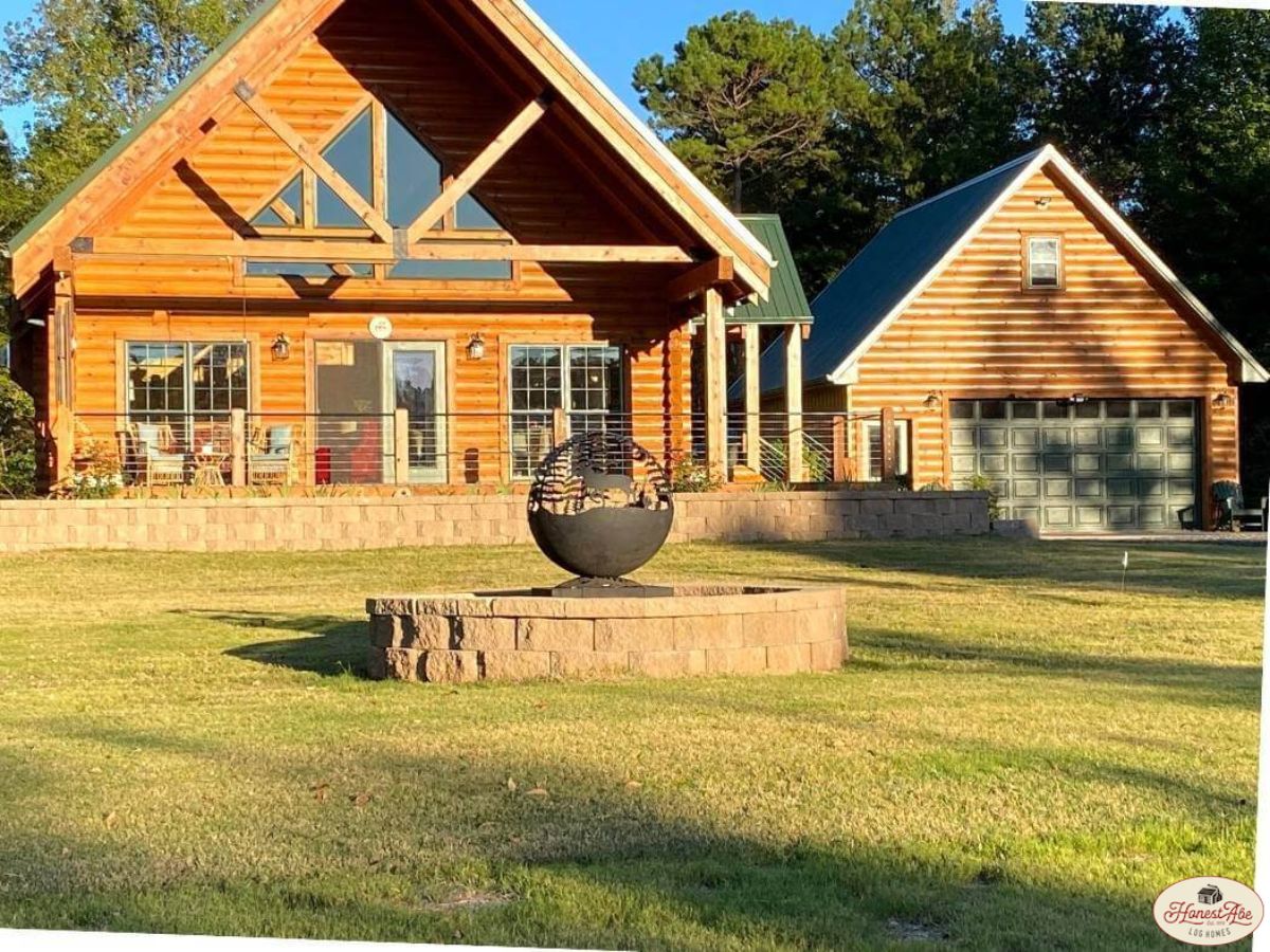 front yard with firepit in front of log cabin with covered deck