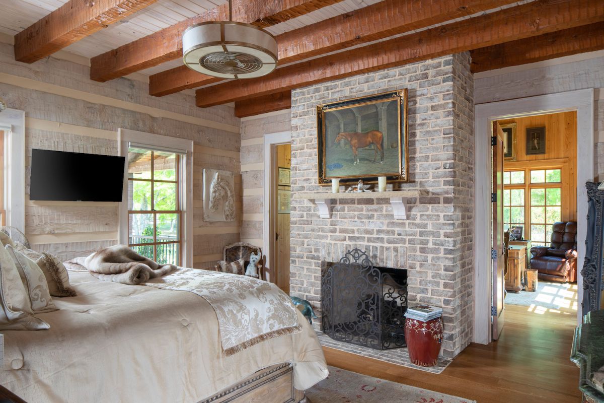fireplace in front of bed in log cabin bedroom
