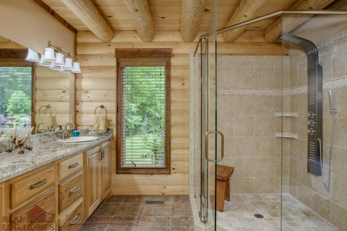 tiled shower in right corner with glass door