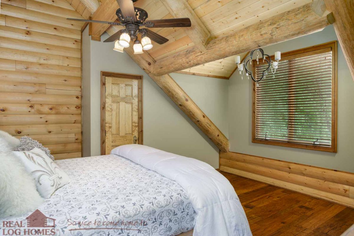 white bedding on bed near wood door with light green painted walls