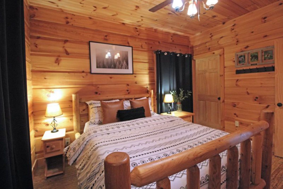 green curtains on windows behind bed in cabin