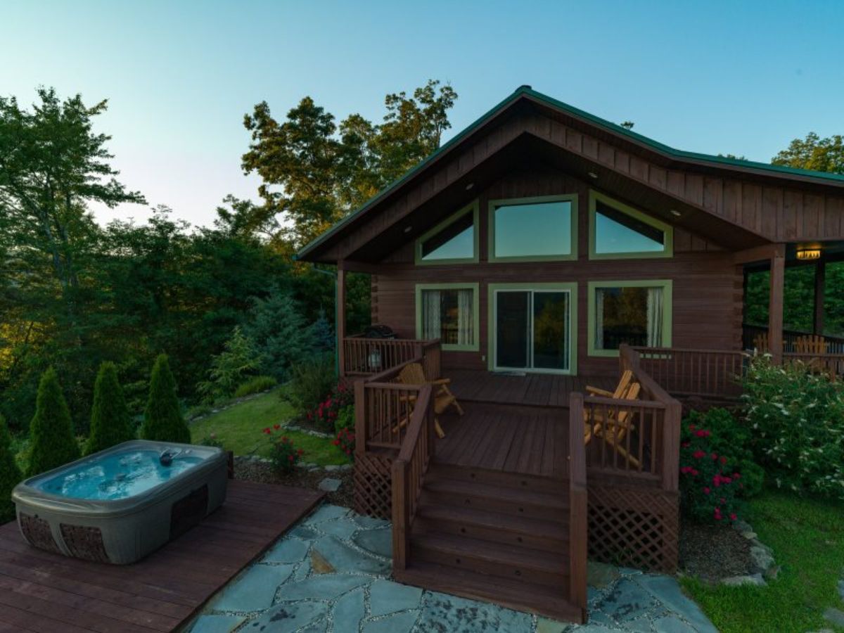 dark wood steps up to wall of windows on cabin