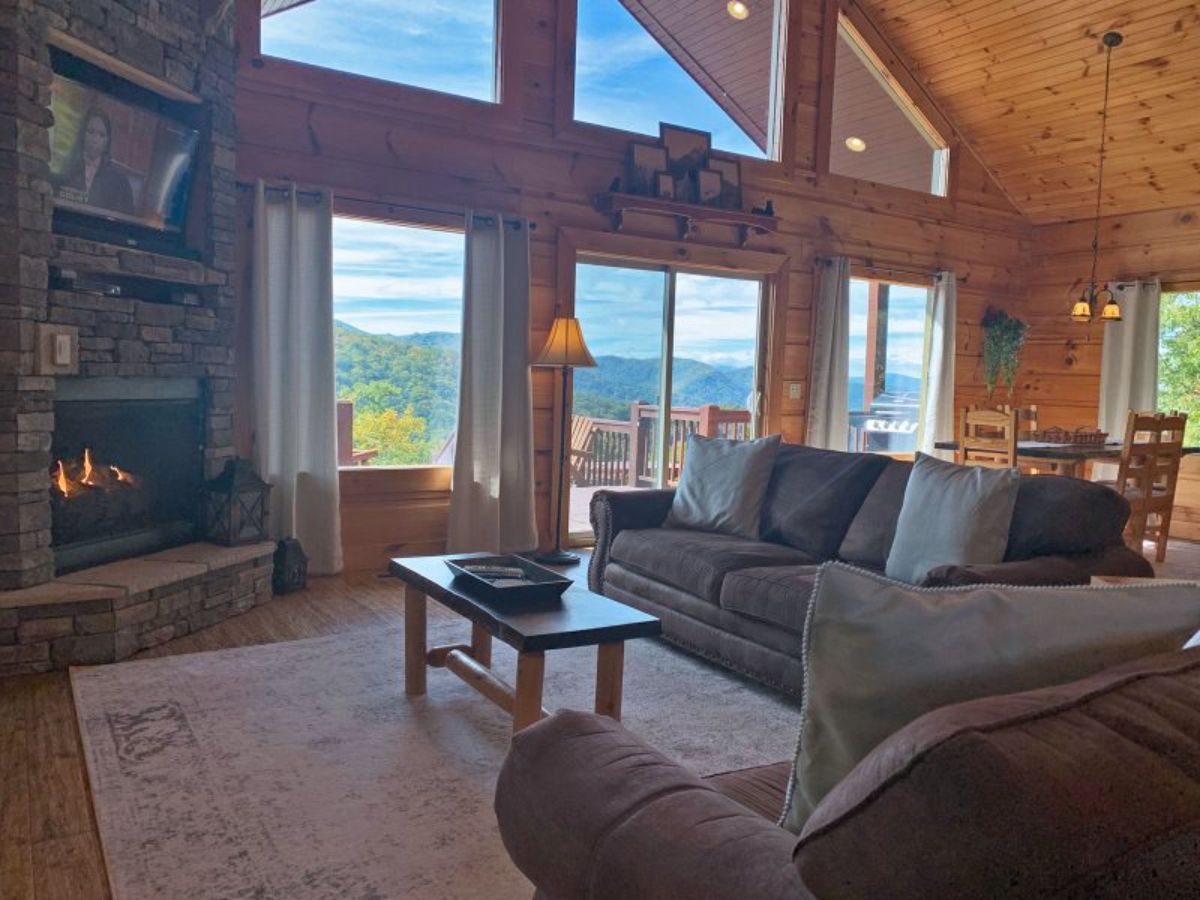 brown sofa and chair in right side of image with fireplace on left back