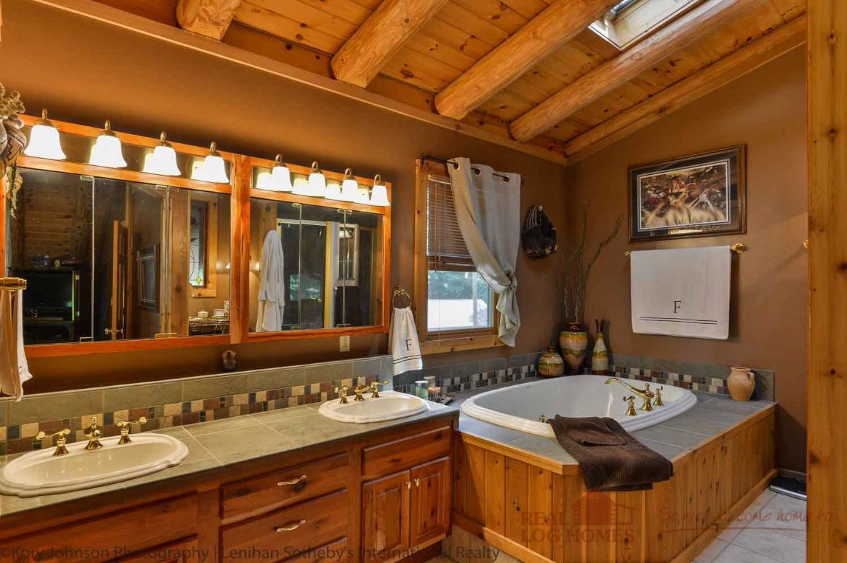 soaking tub in corner of bathroom with wood surround