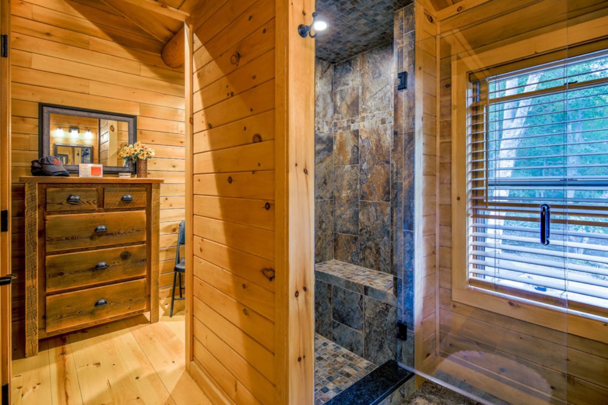 gray tile in shower stall with wood walls