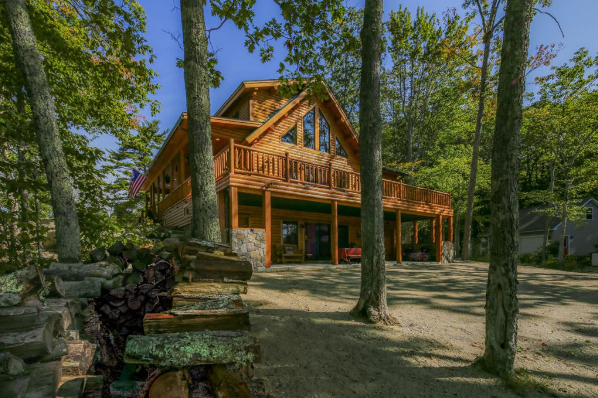 log cabin behind treeline