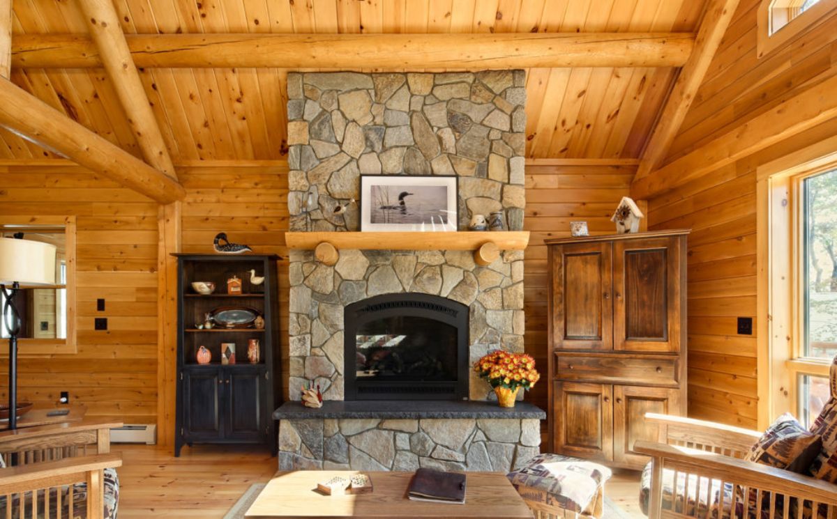 stone fireplace between black and wood wardrobes