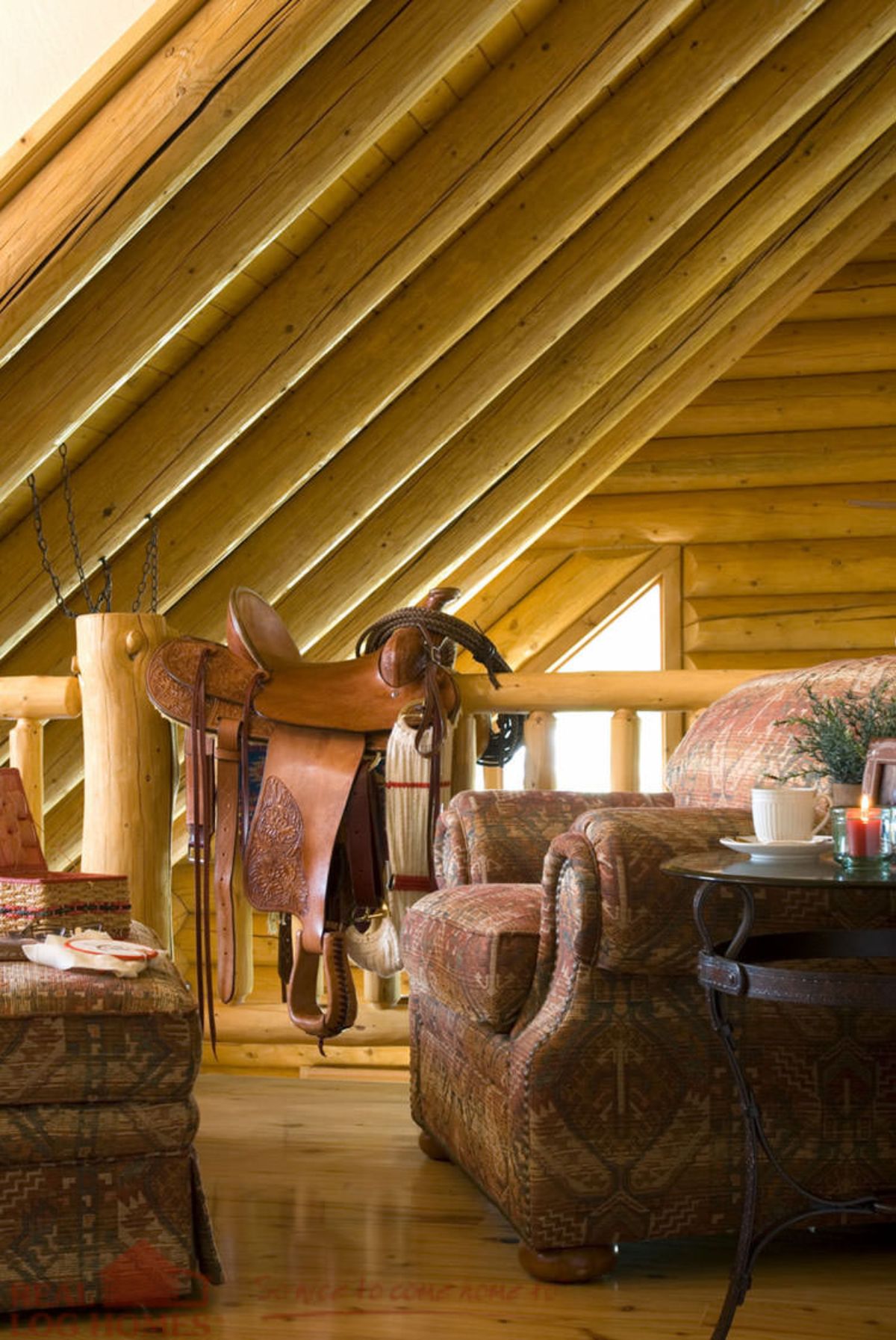 open loft with brown leather sofa and brown saddle over railing