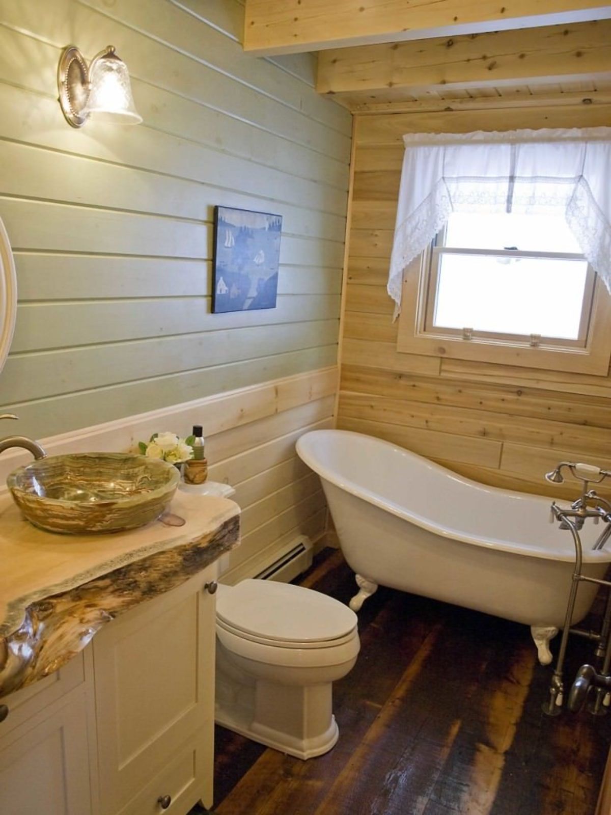 light green walls above light wood wainscotting in bathroom with white soaker tub in corner