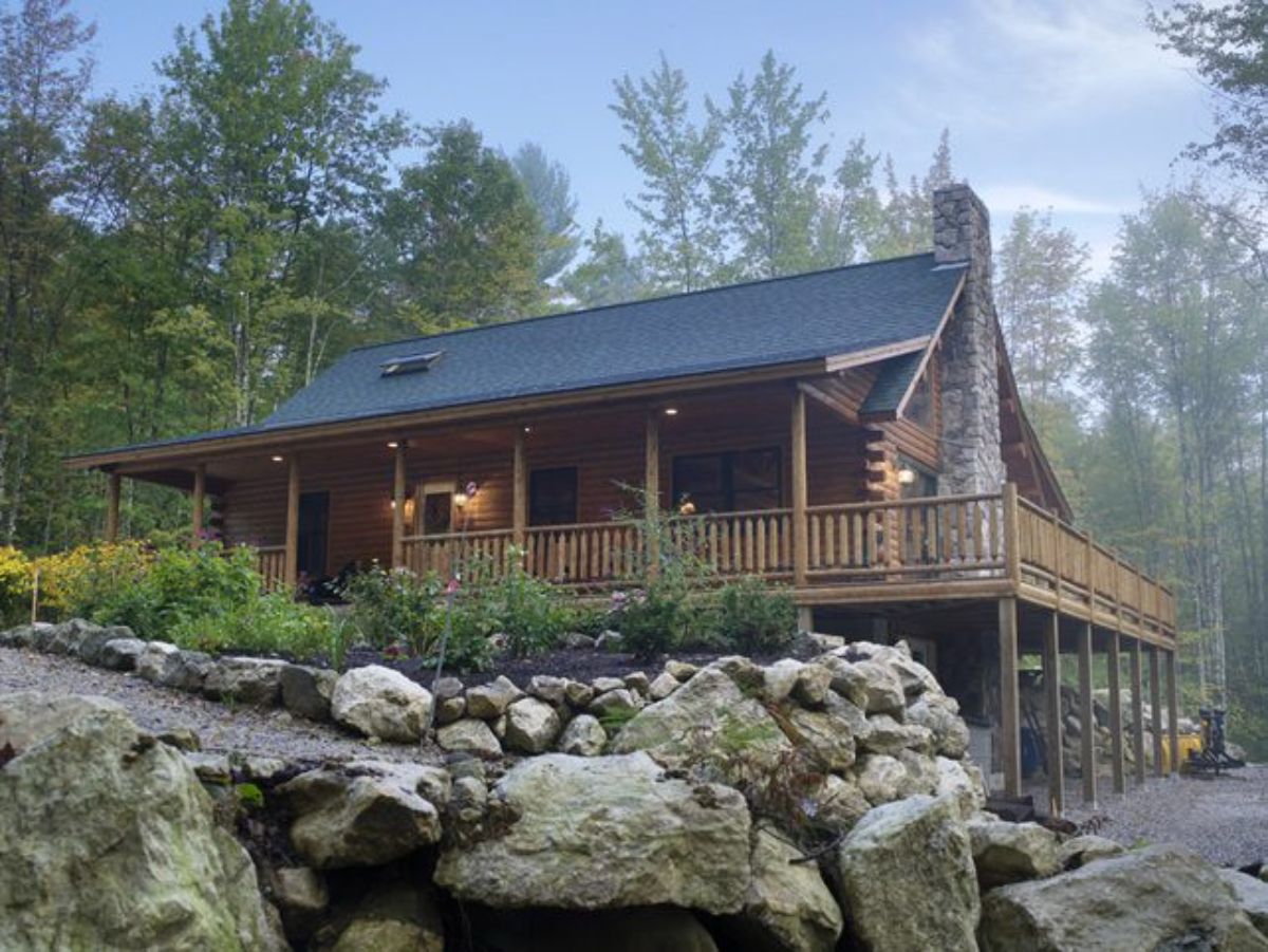 log cabin overlooking stones in creek