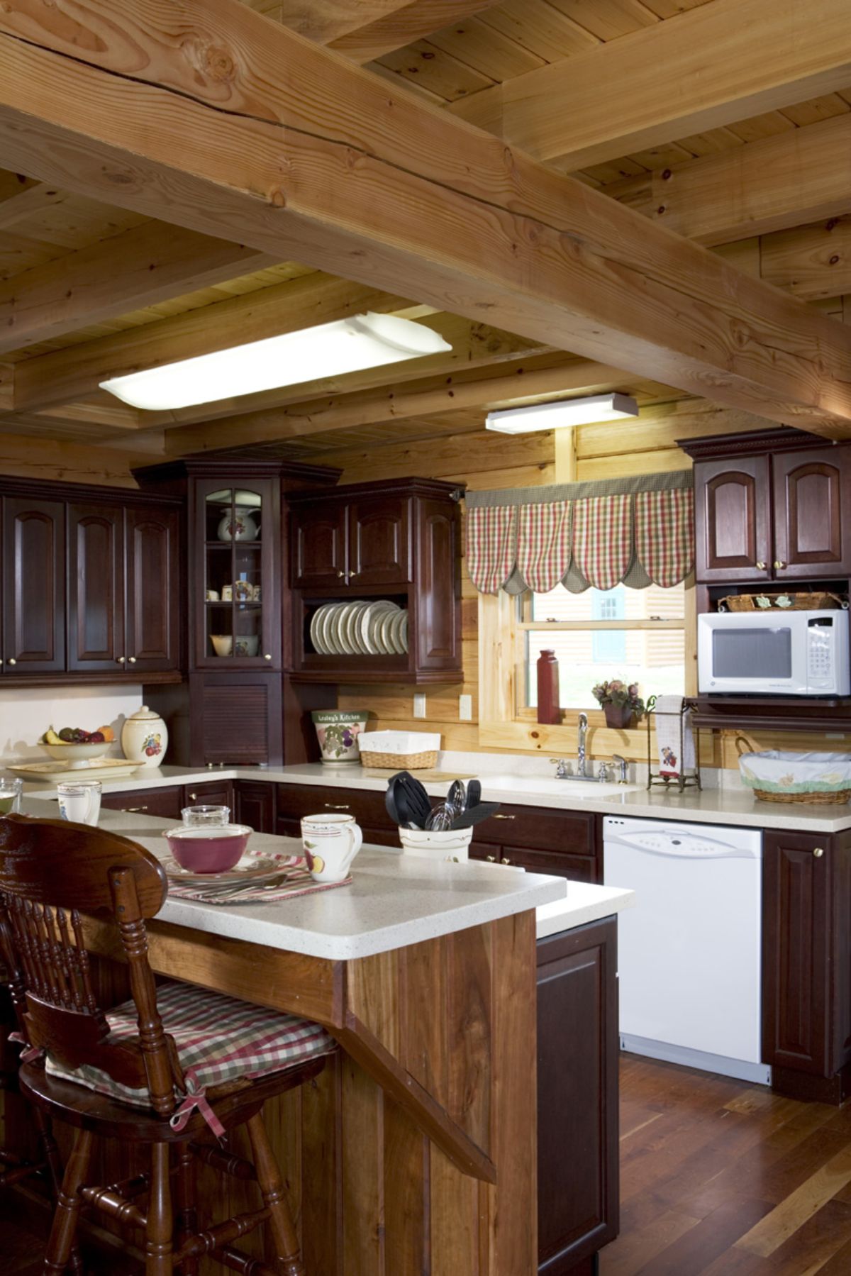 kitchen with dark wood cabinets and white countertops