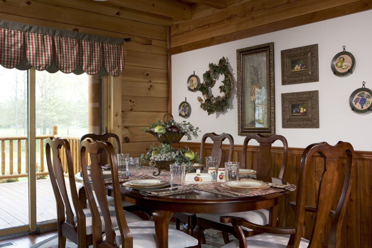 dining table with table runner and place settings by patio door