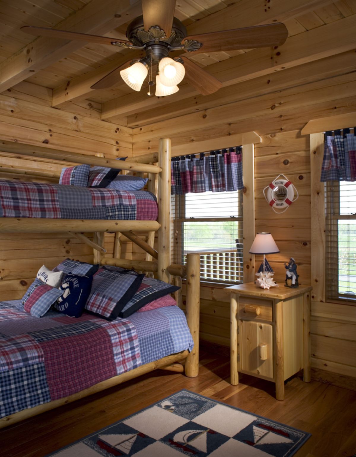 bunk beds against left of log cabin bedroom