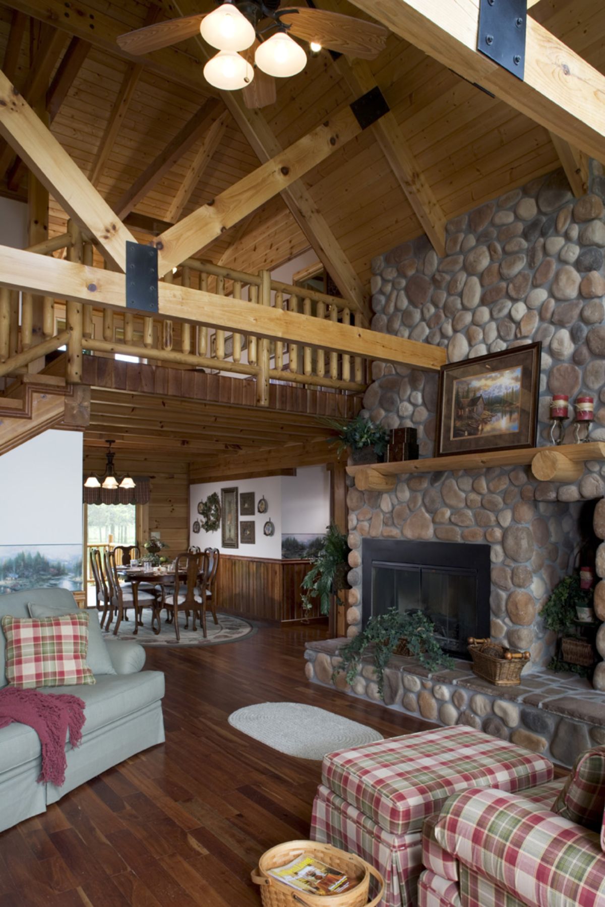 stone fireplace in living space with light gray sofa in front