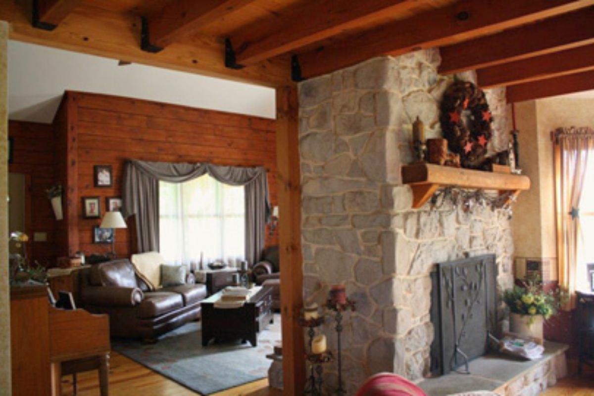 light stone fireplace with living space and sofas on far left side