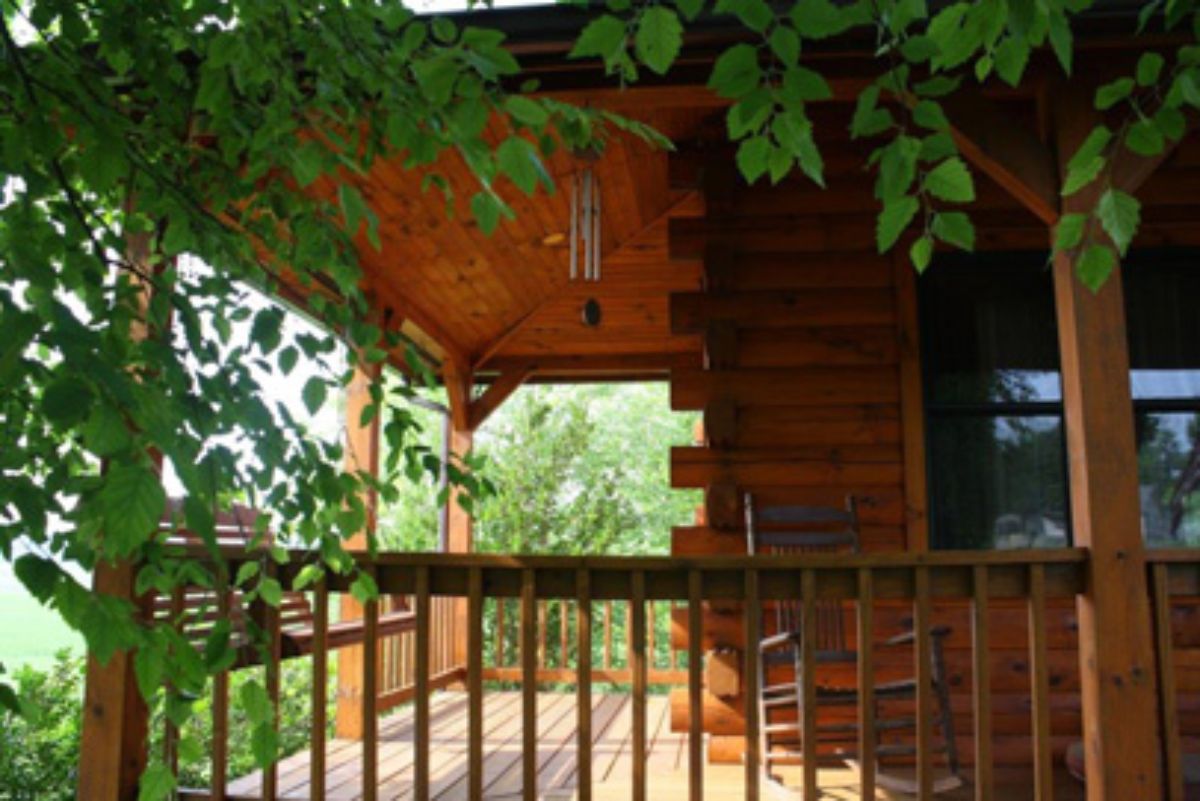 covered porch with d-link corners and ivy hanging over edge of home