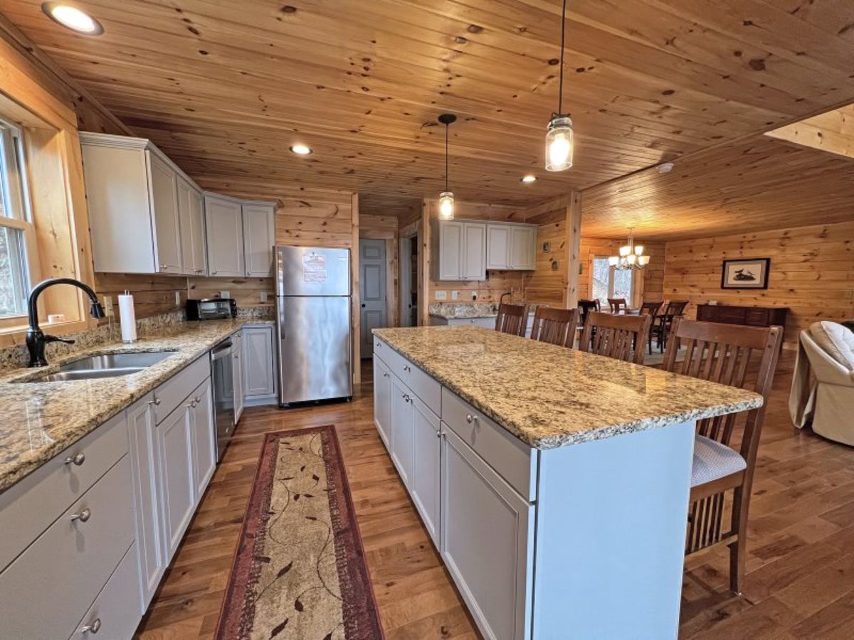 white cabinets and light brown granite countertops in kitchen