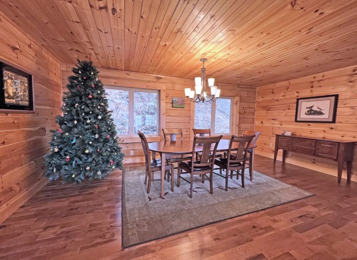 dining table on grey rug by christmas tree