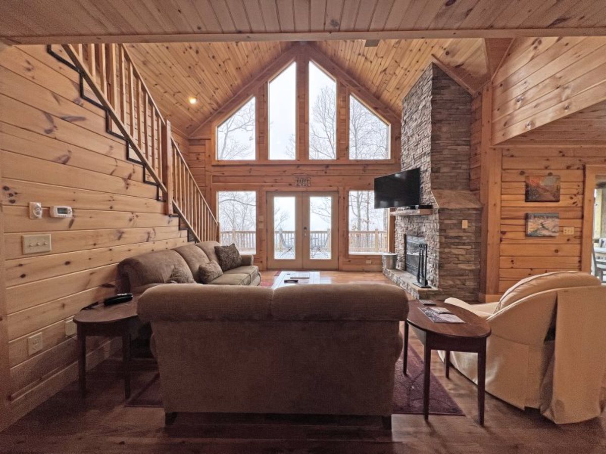 view across back of sofa to wall of windows in great room