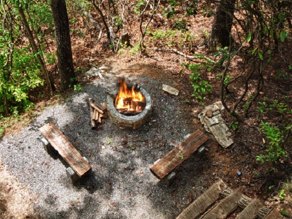 view down onto firepit behind log cabin