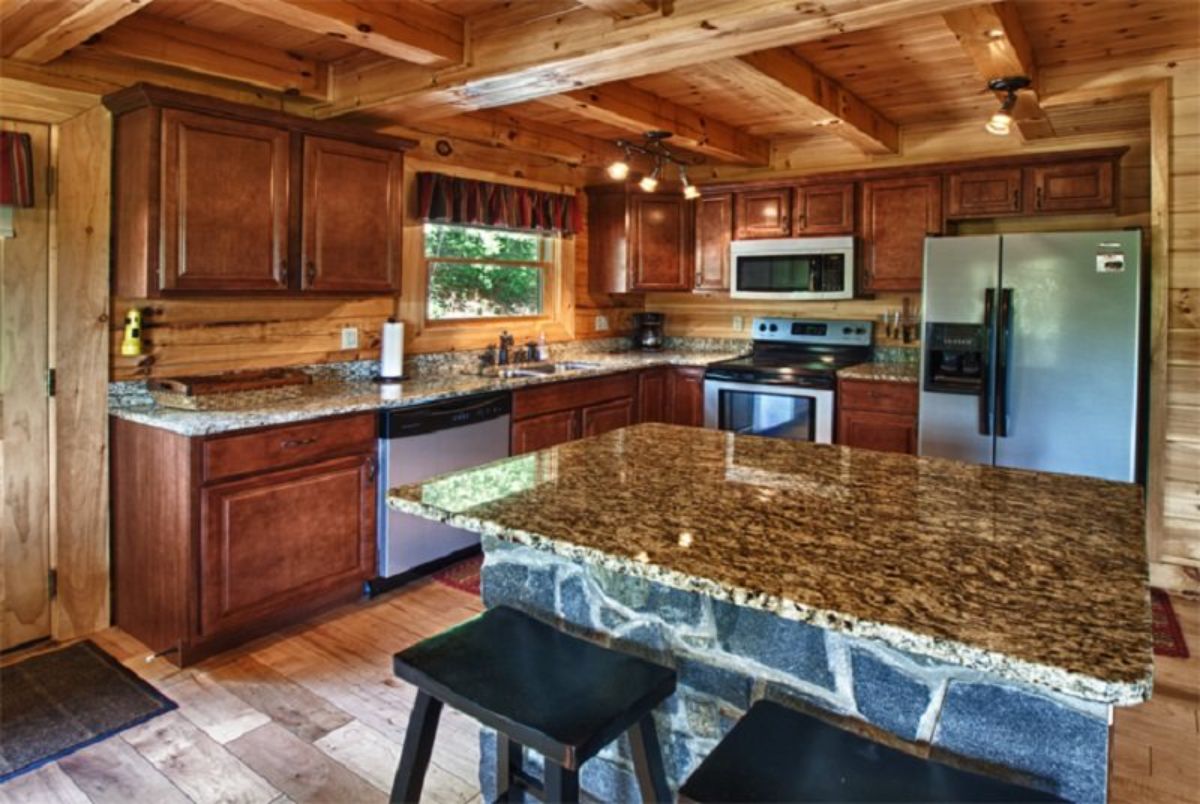marble top on counter on edge of kitchen with wood cabinets
