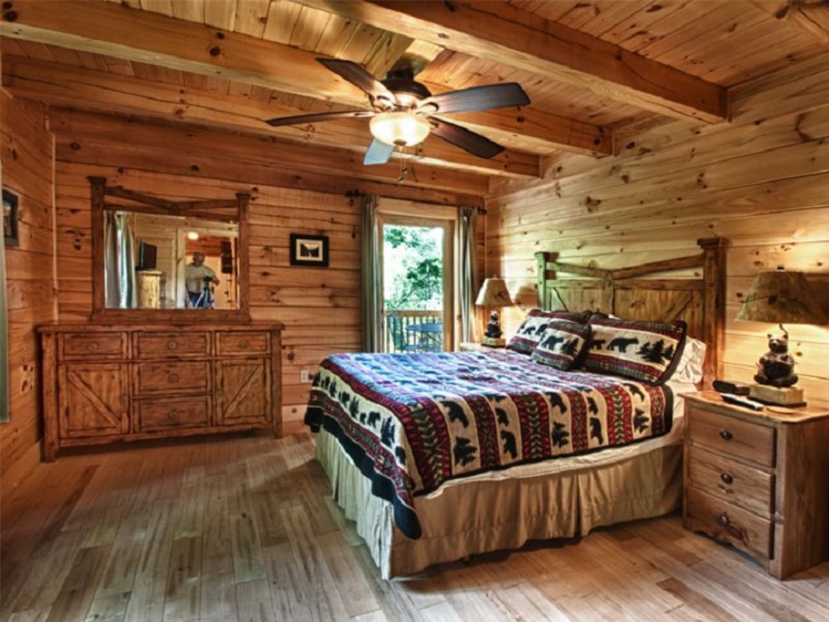 view across bedroom with dresser on wall by window