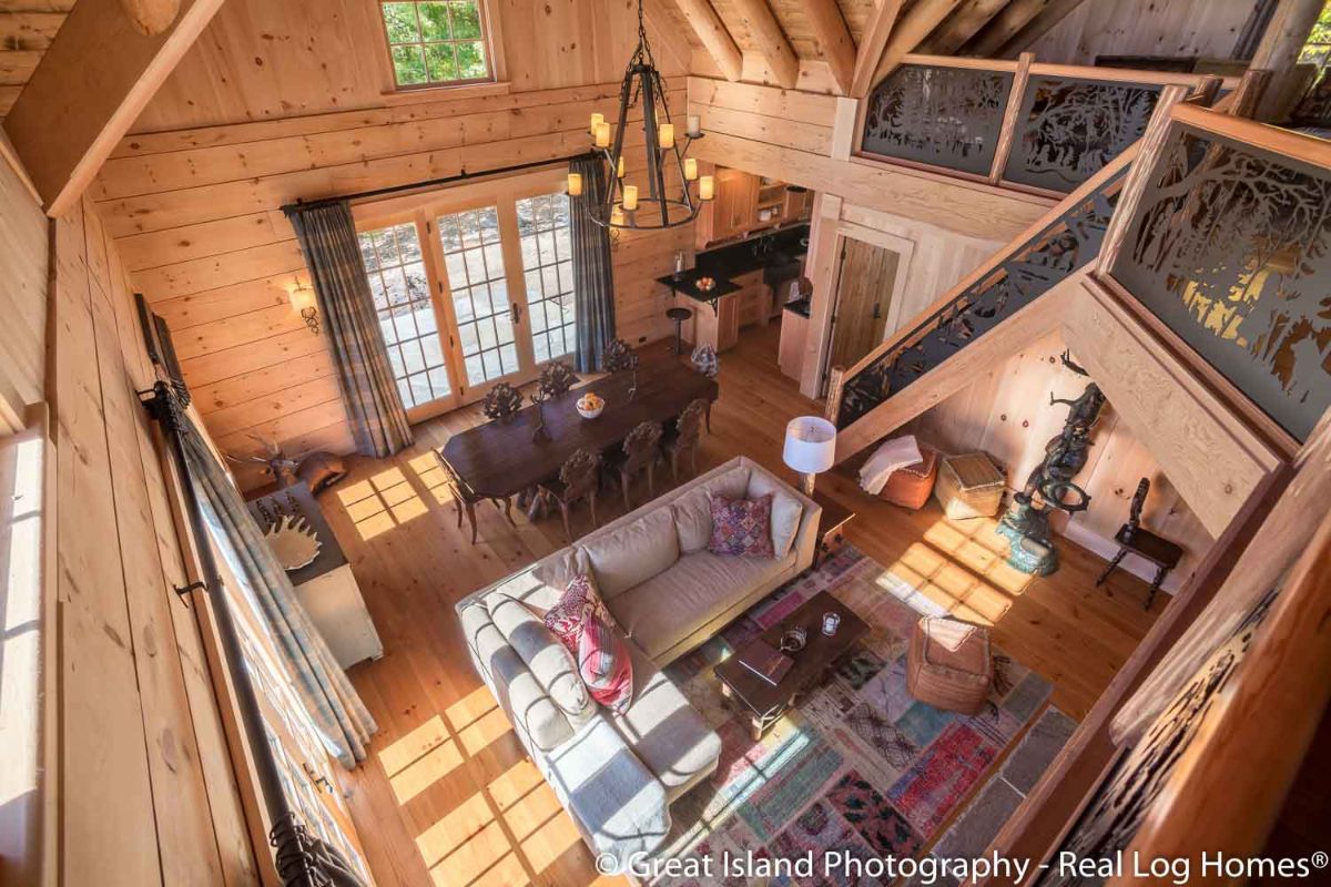 view down into log cabin living room from loft