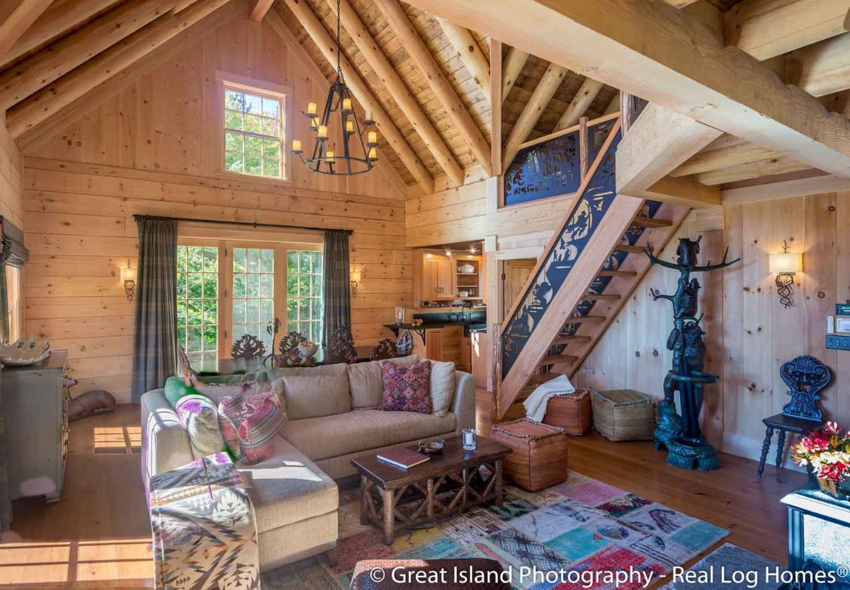 light brown sofa on colorful rug beneath cathedral ceilings