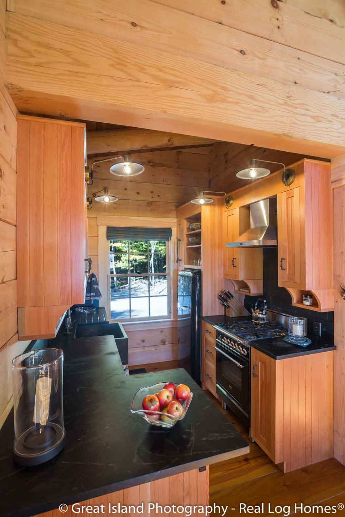 black countertops in kitchen with window at back of image