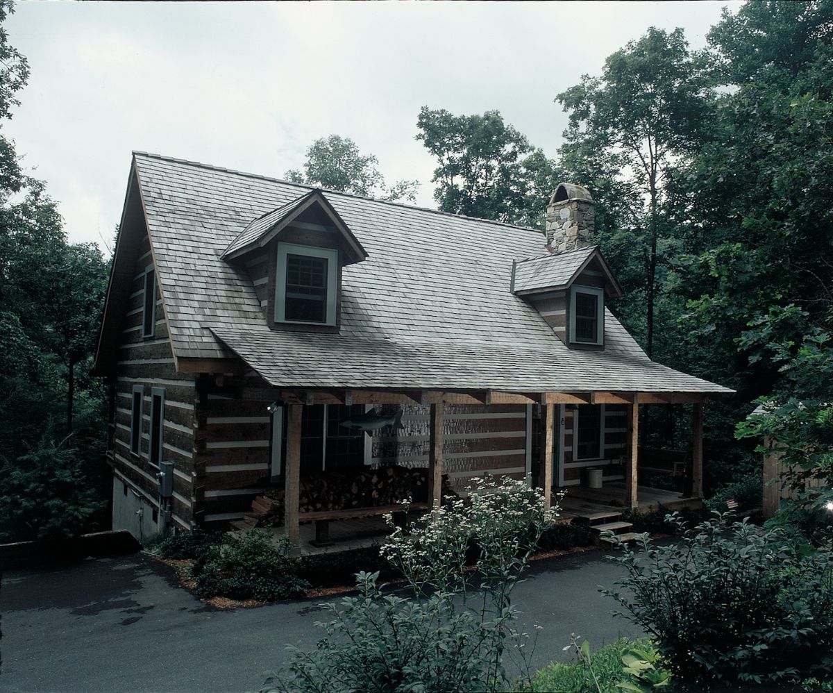 dark wood with white chinking on cabin with light shingles