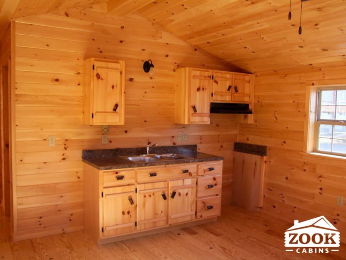 kitchenette with dark counters and wood cabinets