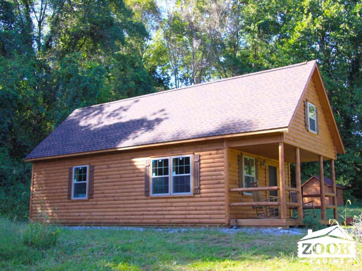 side of log cabin with porch and entry on end of unit