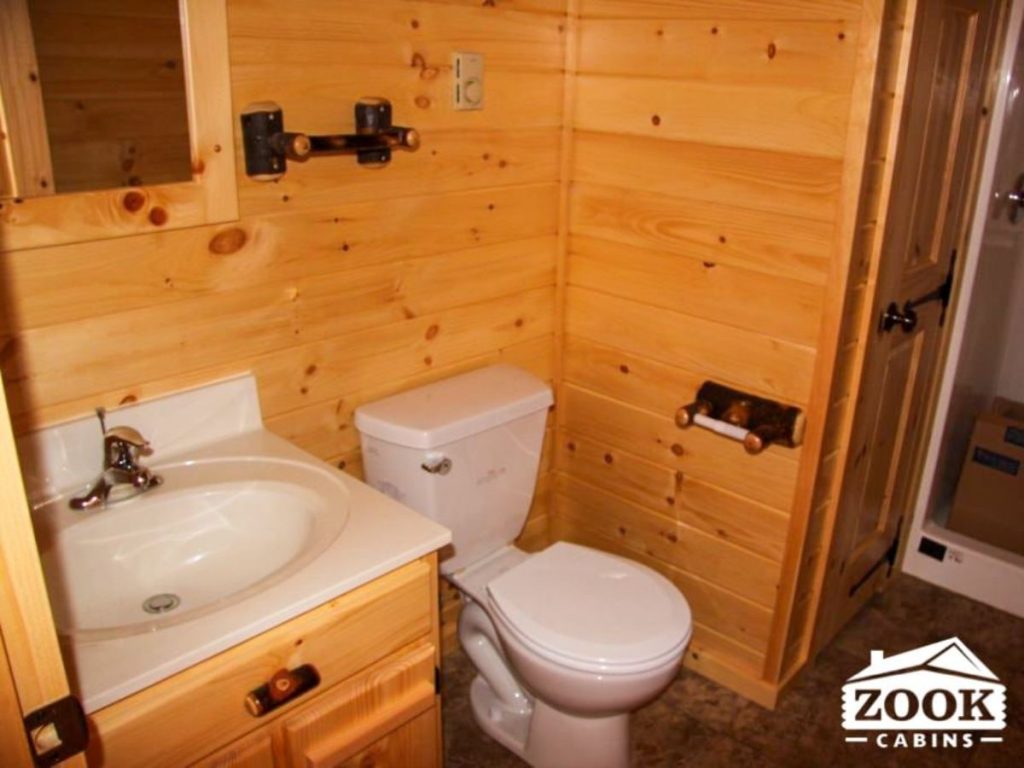 white toilet and sink inside cabin bathroom