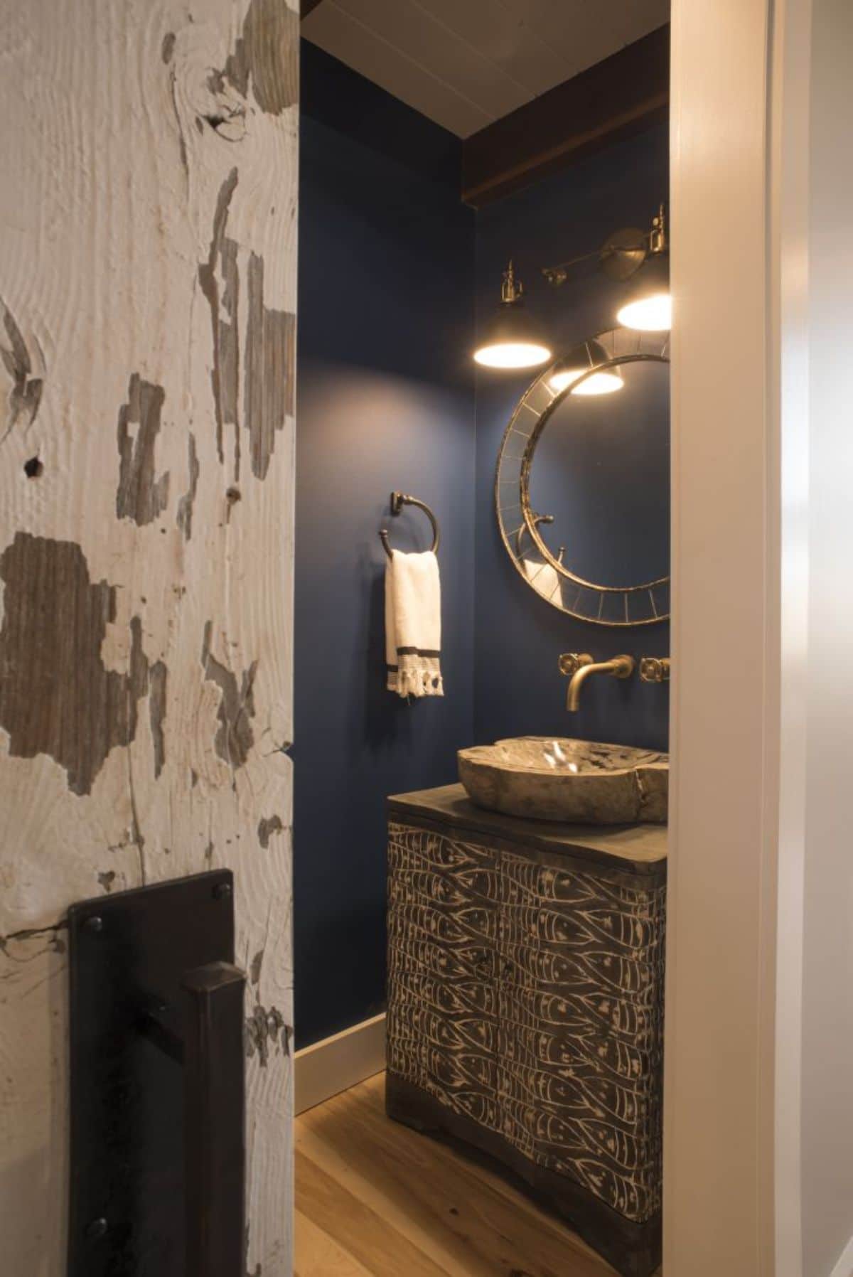 rustic wall in bathroom with blue paint and bowl sink