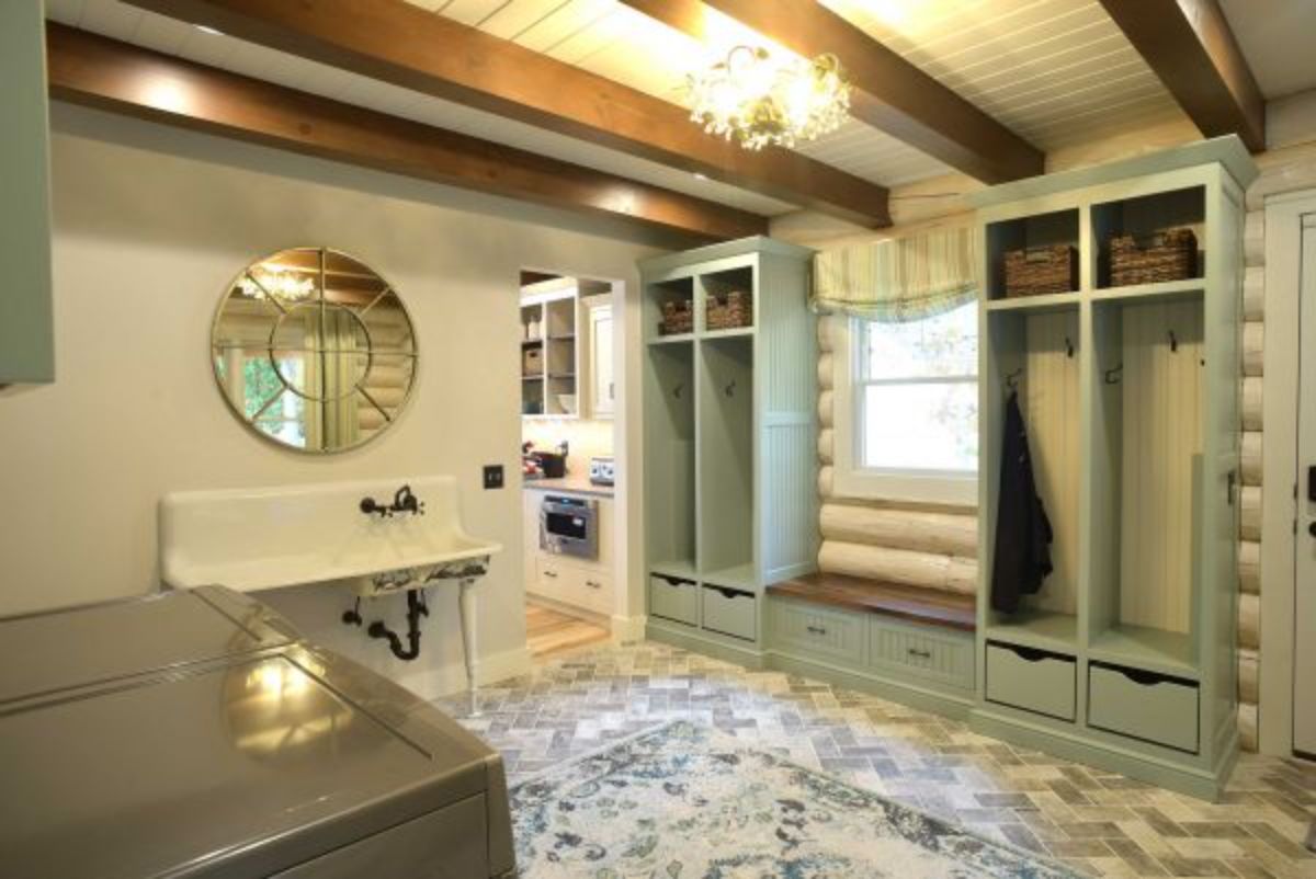 light green open shelving in laundry room with white utility sink on left