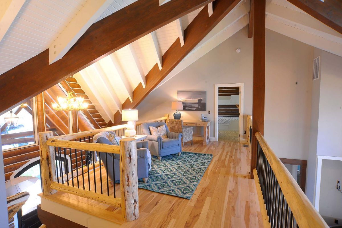 open loft with rug and chairs against railing