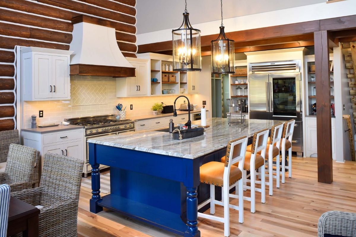blue cabinets in kitchen with whtie and wood stools